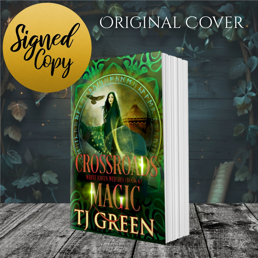 Book titled 'Crossroads of Magic' by TJ Green with a green cover featuring a woman and a bird, on a wooden surface with leaves. Paranormal witch fiction, urban fantasy, mystery
