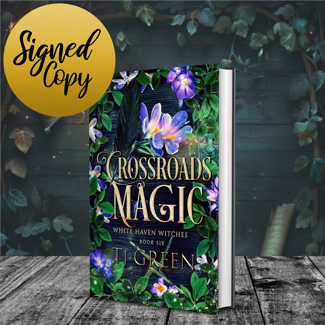 Book titled 'Crossroads Magic' with floral design on a wooden surface and leafy background Paranormal mystery, witchcraft, urban fantasy.