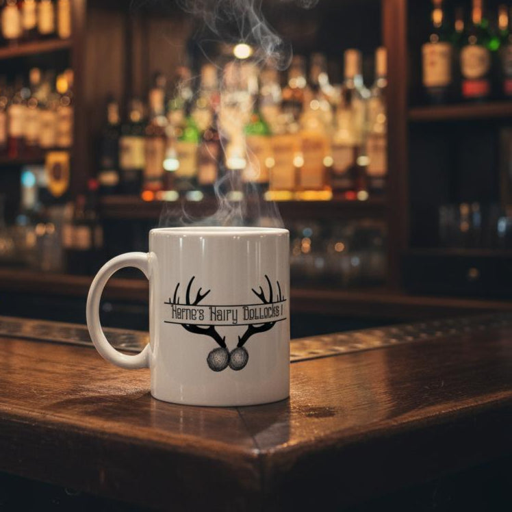 White mug with a logo on a bar counter with bottles and glasses in the background