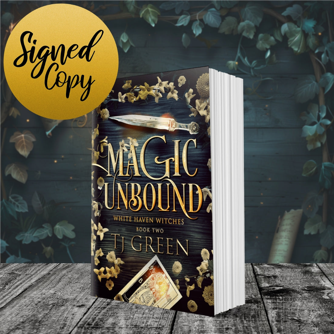 Book titled 'Magic Unbound' by TJ Green on a wooden surface with foliage in the background. Books about witches, White Haven Witches, witch fiction, parab=normal mystery