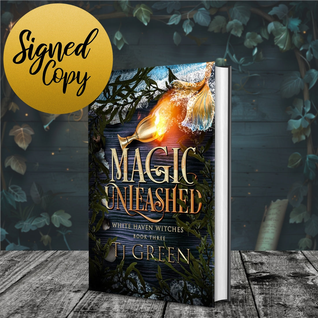 Book titled 'Magic Unleashed' with a signed copy label on a wooden surface with leaves. Witch fiction, paranormal mystery set in Cornwall.