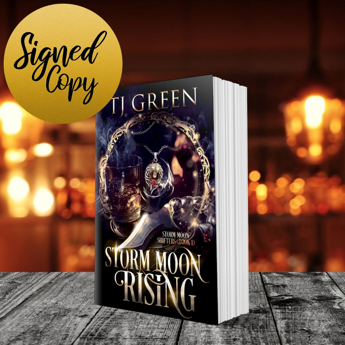 Book titled 'Storm Moon Rising' by TJ Green with a blurred background of lights. Urban Fantasy wolf-shifter series. Paranormal mystery.