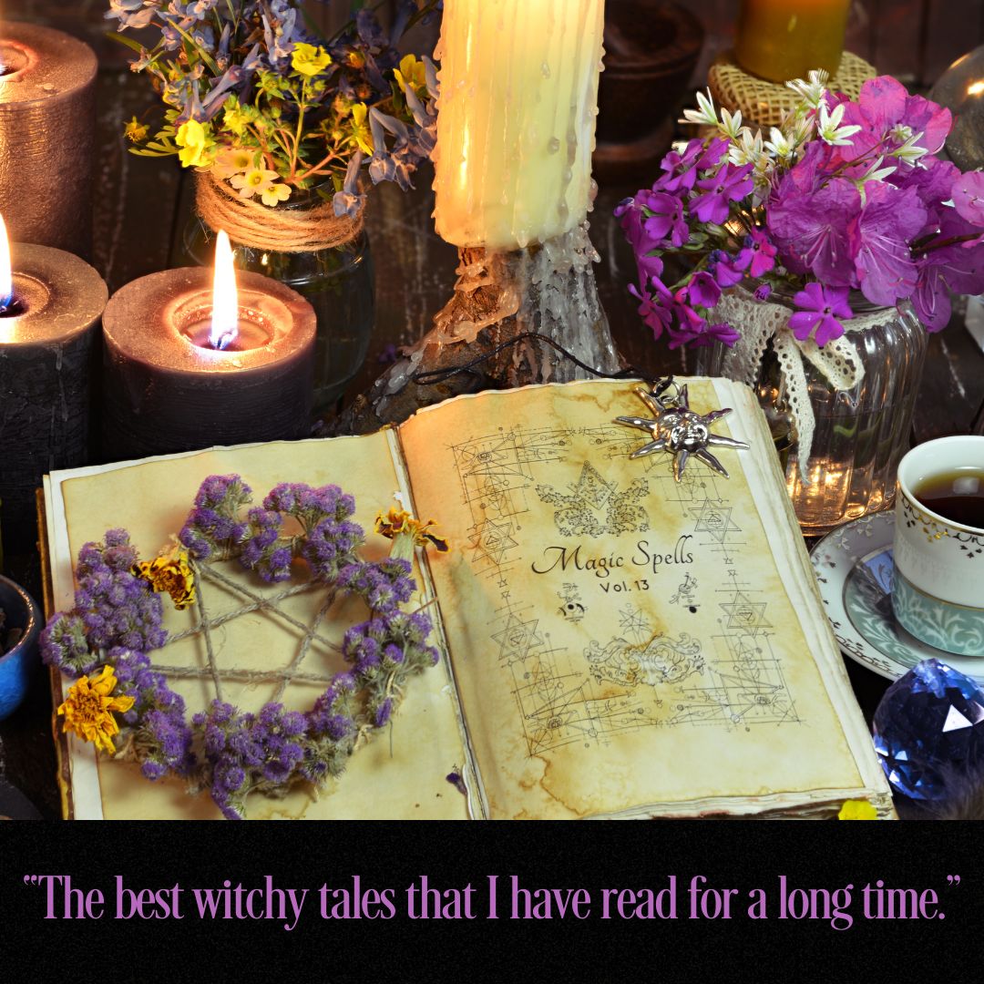 An open vintage-style book titled "Magic Spells Vol.13" lies on a dark surface, surrounded by lit candles, purple flowers, a small spider charm, and a cup of tea.