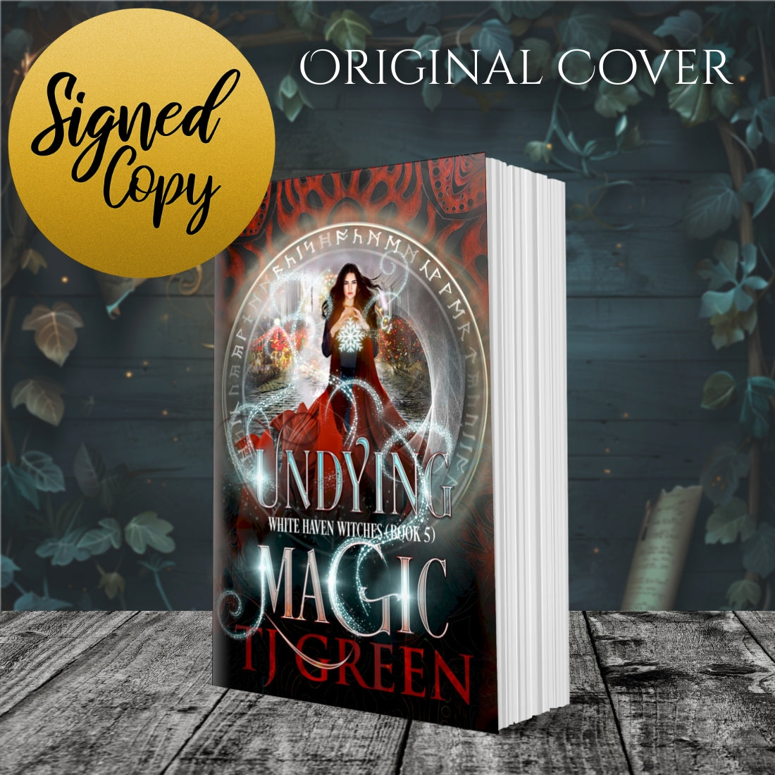 Book titled 'Undying Magic' by IJ Green on a wooden surface with foliage in the background. Paranormal witch fiction, supernatural, urban fantasy/