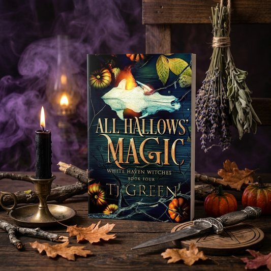Book titled 'All Hallows Magic' by TJ Green surrounded by Halloween-themed decorations on a wooden surface.