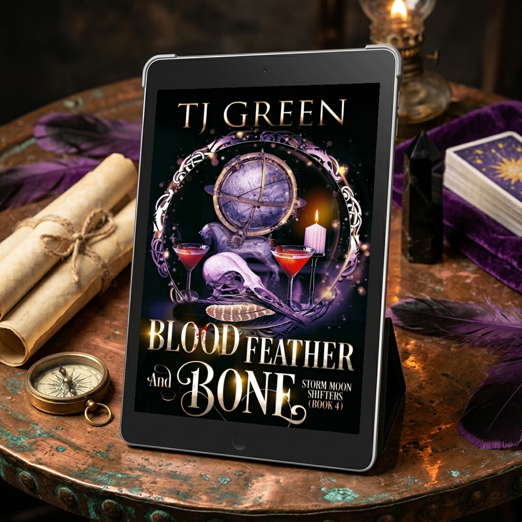 A tablet displaying the book cover of 'Blood Feather and Bone' by TJ Green, styled on a rustic copper table with occult-themed props including feathers, a compass, candles, and a tarot deck.
