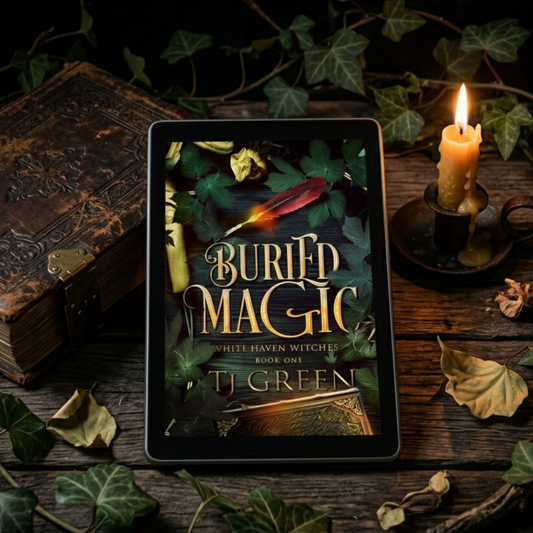 Buried Magic ebook by TJ Green on an old table with a leather bound book, a candle, and ivy.