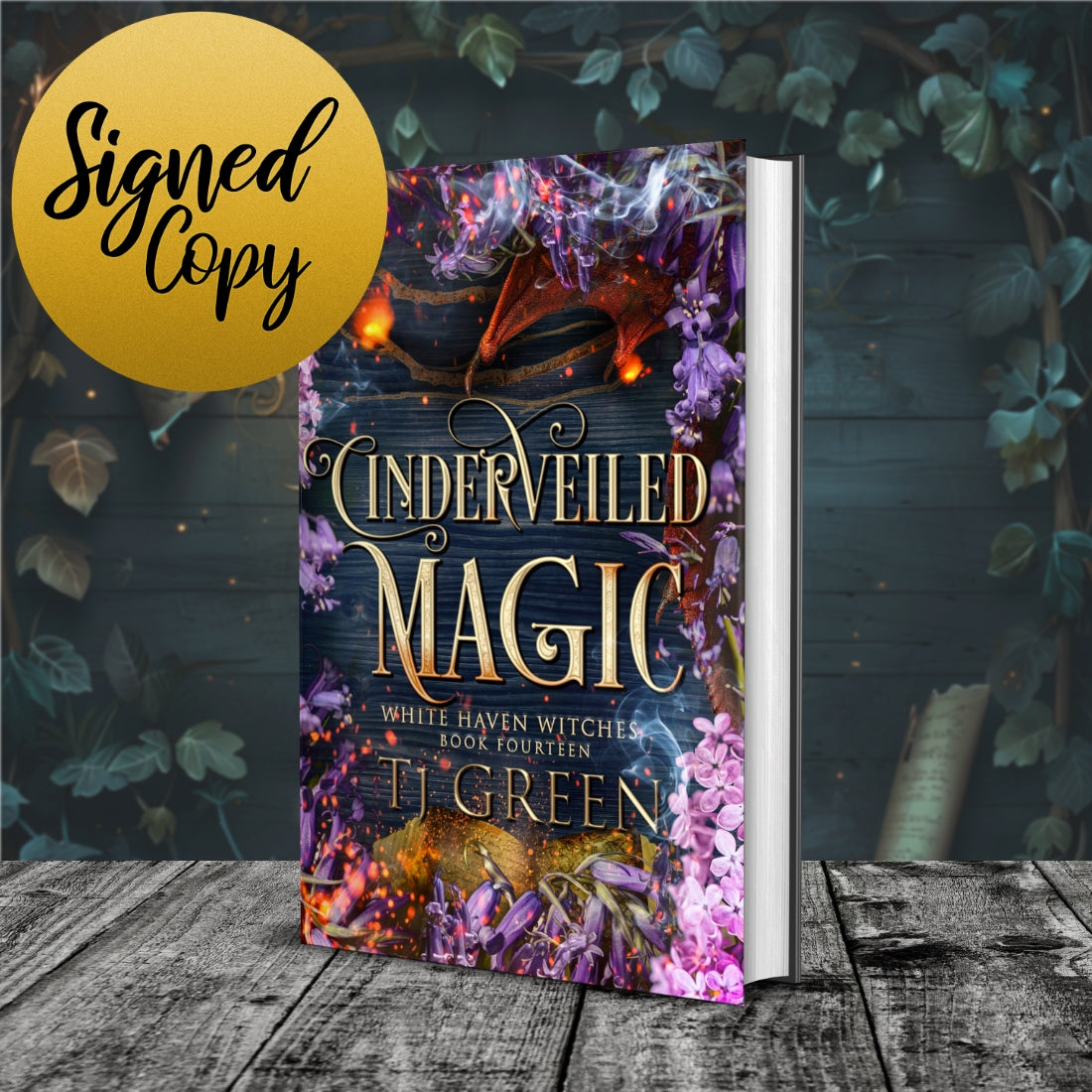 Book titled 'Cindeveiled Magic' by T.J. Green with a decorative cover on a wooden surface.