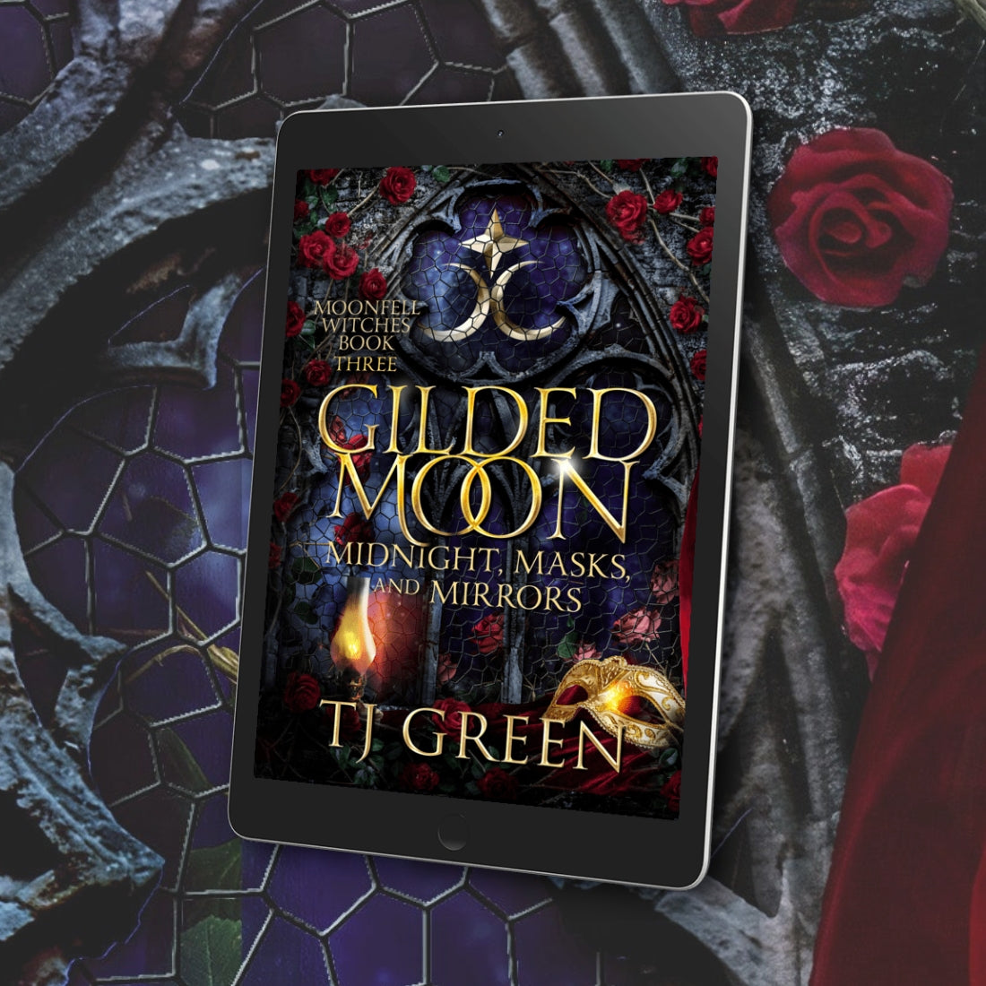 E-reader displaying the cover of 'Gilded Moon' by TJ Green against a dark, mystical background with roses.