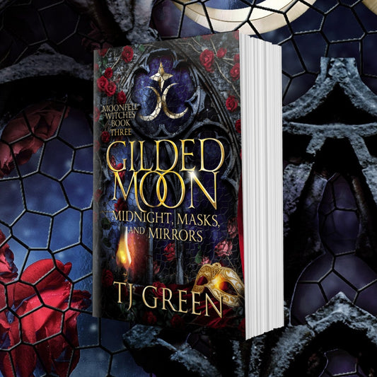 Book titled 'Gilded Moon: Midnight, Masks, and Mirrors' by TJ Green with a mystical background.