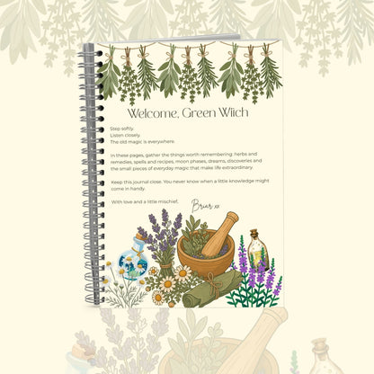 A spiral-bound journal titled 'Welcome, Green Witch' with botanical illustrations, shown standing upright on a light cream background with subtle leafy and scroll motifs.