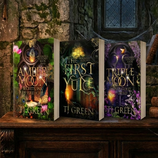Three books titled 'Amber Moon', 'The First Yule', and 'Triple Moon' by T.J.