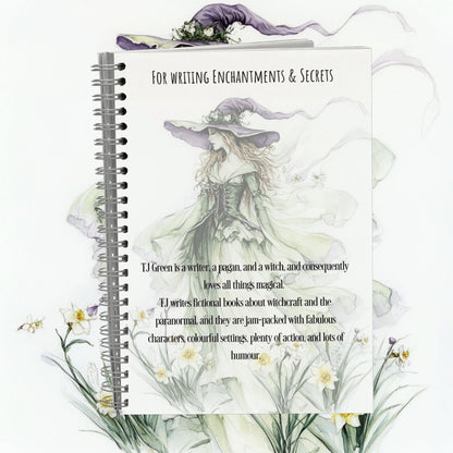 Notebook with a witch illustration and text on a white background