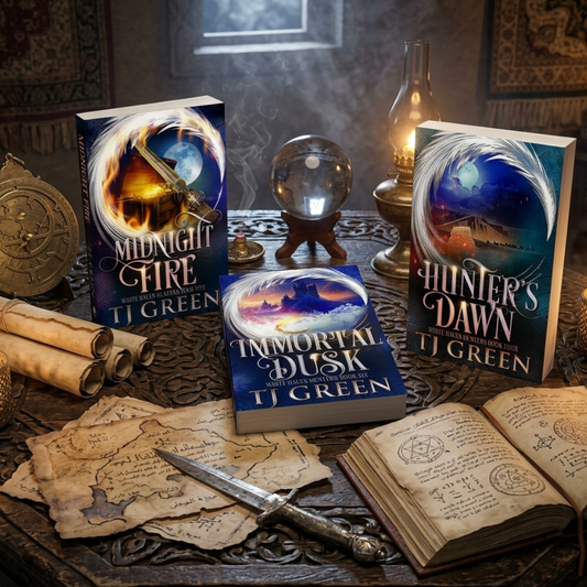 Three fantasy book covers by TJ Green are arranged on a dark wooden table with candles, parchment, a compass, a crystal ball, and an open book in a moody, atmospheric setting. The books are titled Midnight Fire, Immortal Dusk, and Hunter's Dawn.