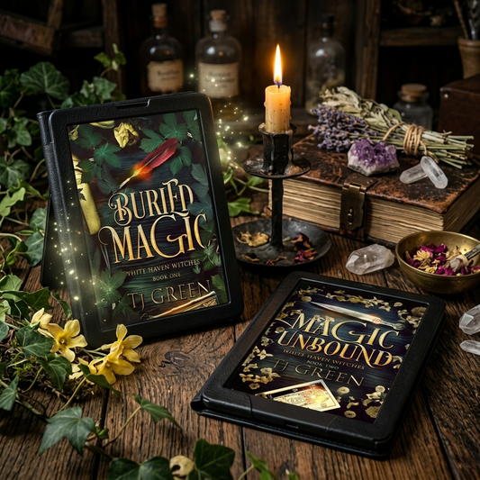 Two black tablet devices displaying book covers from the 'Buried Magic' series by J. Green, styled on a rustic wooden table with a lit candle, crystals, dried flowers, and old books.